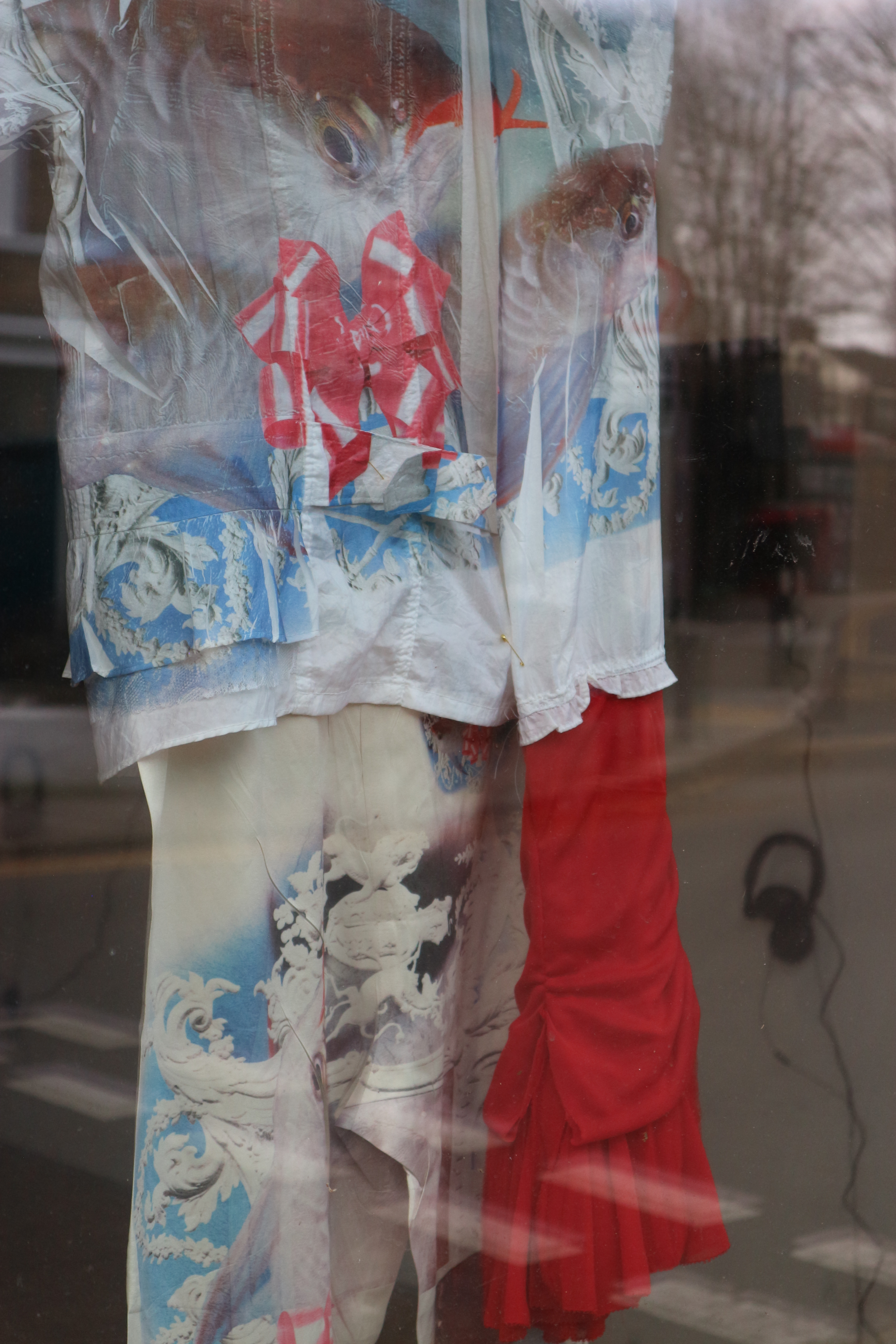 Close up photo of a bright blue, red and white costume with different textures.